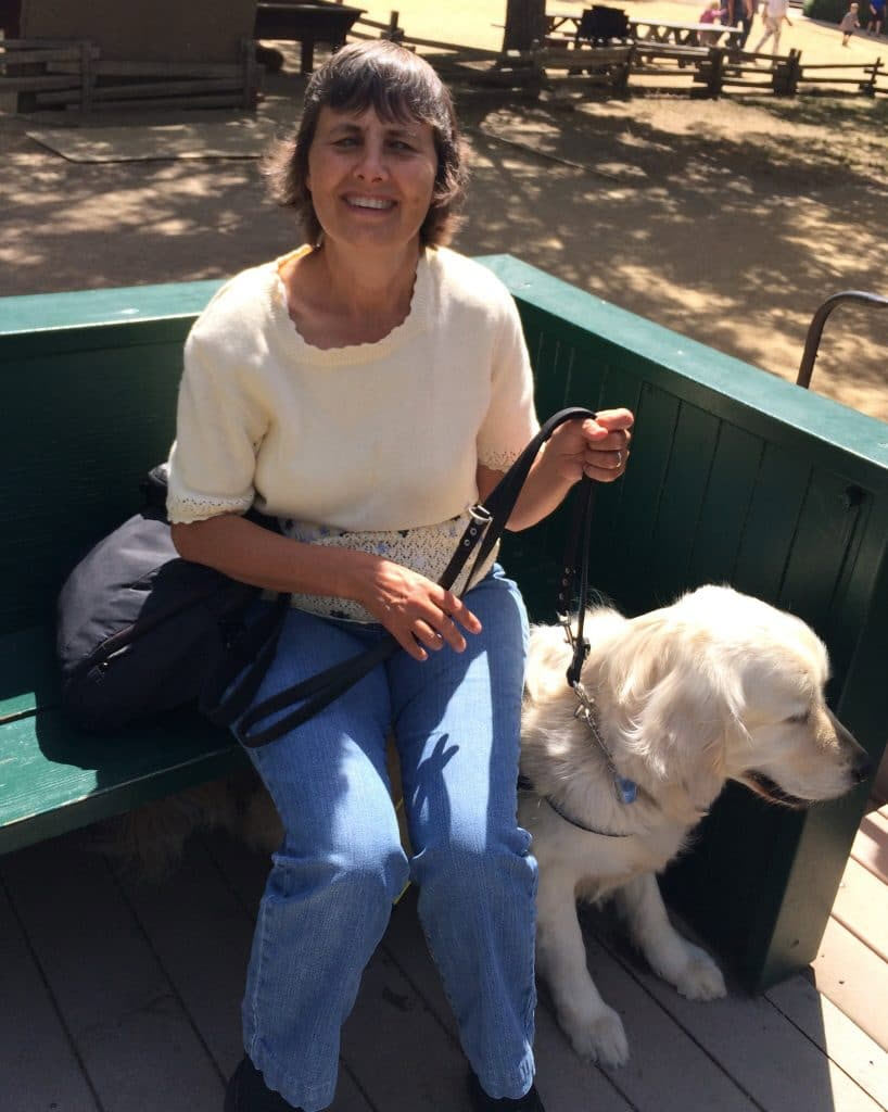 A photo of Tamara Kearney with her guide dog, probably at History Park in San Jose, CA.